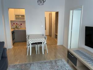 a living room with a table and a kitchen at COOKIE Apartment in Zagreb