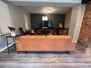 a living room with a couch and a flat screen tv at **Stylish Pet Friendly 3 Bedroom House** in Cleveland