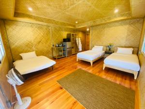 a room with two beds and a fan at Daelorpu 2 แดลอปู in Ban Yang