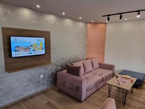 a living room with a couch and a flat screen tv at Villa Park Ravne in Visoko +94 photos