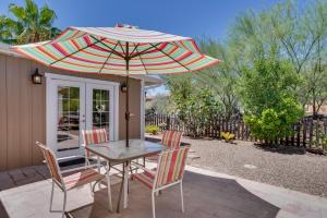 a table and chairs with an umbrella on a patio at Green Valley Vacation Rental Apt with Patio and Grill! in Green Valley