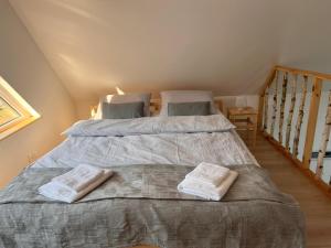 a bedroom with two beds and a staircase at Brzozlove in Nadole