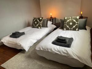 two beds in a room with towels on them at Floyter House North Yorkshire Moors National Park in Danby +35 photos