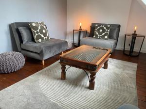 a living room with two chairs and a coffee table at Floyter House North Yorkshire Moors National Park in Danby