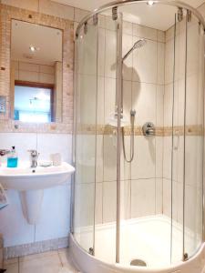 a bathroom with a shower and a sink at Seafront Holiday Home in Southend-on-Sea