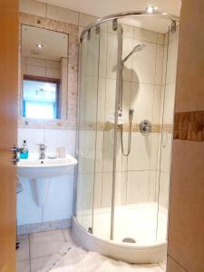 a bathroom with a shower and a sink at Seafront Holiday Home in Southend-on-Sea