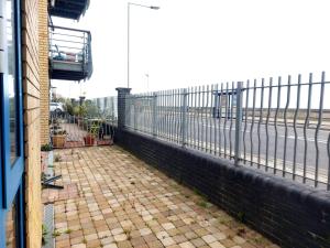 a balcony with a view of the ocean and a fence at Seafront Holiday Home in Southend-on-Sea