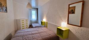 - une chambre avec un lit et deux lumières sur le mur dans l'établissement Apartamentos Grifovacances Canigou, au Pas de la Case