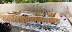 a wooden tub with some shoes in it at Homestay D'reendang in Yan
