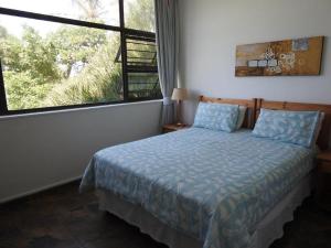 a bedroom with a bed and a large window at Marlicht Vacation Resort in Margate