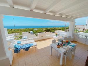 a balcony with a table and chairs and the ocean at Residence Salento Fronte Mare - Coste del Sud it in Torre San Giovanni Ugento