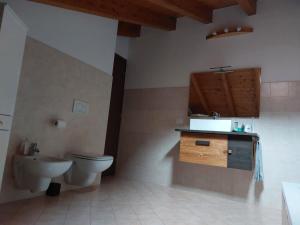 a bathroom with a toilet and a sink at Ai piedi della grigna in Pasturo