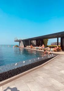 a swimming pool with people laying in the water at The base Central Pattaya 903 by Numam in Pattaya Central