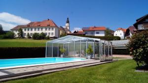 ein Gewächshaus um einen Pool im Hof in der Unterkunft Haus Rose in Wenigzell