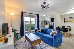 a living room with a blue couch and a table at Hip Austin Vacation Rental 3 Mi to Downtown in Austin