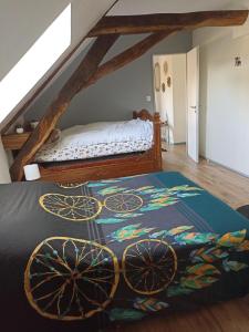 a bedroom with a bed with a rug on the floor at La Bruyère - B & B - in Tréban