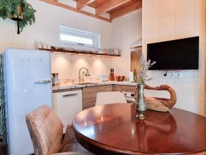 a kitchen with a table and a refrigerator at Vakantiehuis Dishoek DI04 in Dishoek