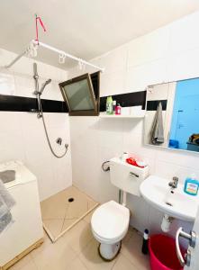 a bathroom with a white toilet and a sink at Уютная Квартира 1,5 комнаты. in Haifa