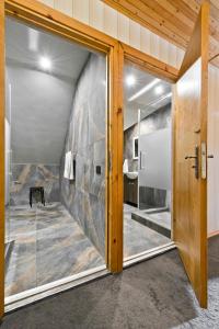 a large glass door in a room with a stone wall at Vila Vika in Palanga +125 photos