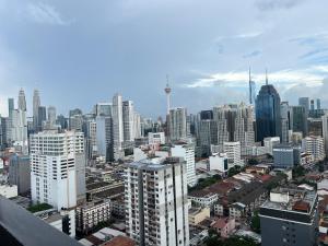 a view of a city skyline with tall buildings at Cozy luxury couple studio apartment chambers kl klcc kl tower view in Kuala Lumpur