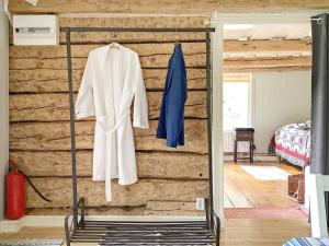 a white coat on a rack in a room at Holiday home Uppsala in Uppsala