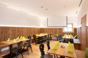 a dining room with tables and chairs and a whiteboard at Landgasthof Maier in Vilsbiburg