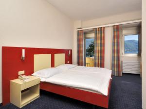 Un pat sau paturi într-o cameră la Hotel Arancio
