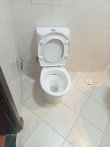 a bathroom with a white toilet in a stall at بورتو السخنه in Ain Sokhna