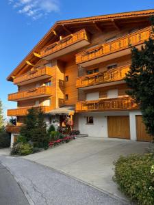 a large building with balconies on the side of it at La casetta di Crans in Crans-Montana
