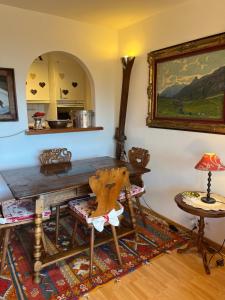 a dining room with a wooden table and a chair at La casetta di Crans in Crans-Montana