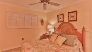a bedroom with a bed and a ceiling fan at Aegean 215 - Beautiful Beachfront Condo Lots of on site Activities in Destin +18 photos