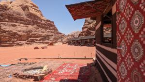 a building in the desert with a view of a mountain at WhyDesert Camp & Tours in Wadi Rum