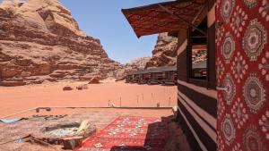 un edificio nel deserto con vista su una montagna di WhyDesert Camp & Tours a Wadi Rum