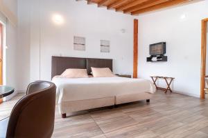Postel nebo postele na pokoji v ubytování Hotel Gran Boutique Sabana