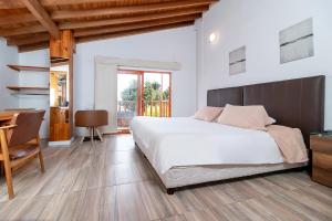 Postel nebo postele na pokoji v ubytování Hotel Gran Boutique Sabana