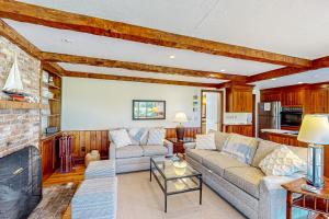 a living room with a couch and a fireplace at Eagle's Nest in Yarmouth Port