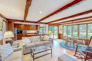a living room with a couch and a table at Eagle's Nest in Yarmouth Port