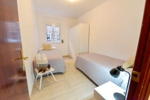 a small bedroom with two beds and a chair at New! Spacious & River in Seville