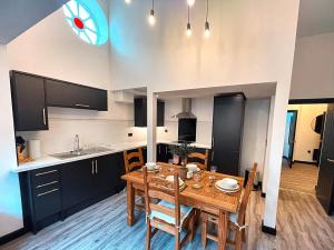 a kitchen and dining room with a wooden table at The Beaumonts in Darlington