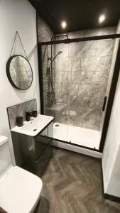 a bathroom with a shower and a toilet and a sink at The Beaumonts in Darlington