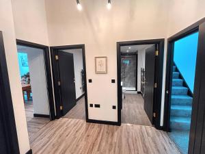 a hallway with doors and a staircase with blue steps at The Beaumonts in Darlington