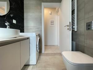 a bathroom with a sink and a washing machine at Urban Oasis in Ellinikon in Athens
