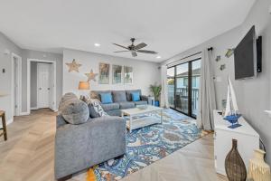 a living room with a couch and a tv at Crystal Village II 6B - Close to the Beach 2BD 2BA in Destin