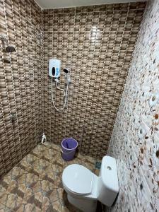 a bathroom with a toilet and a shower at Homestay PCB Villa MamaKaya in Kota Bharu +12 photos