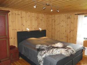 a bedroom with a bed with a furry blanket on it at Holiday Home Brandsbu - SOW097 by Interhome in Åseral