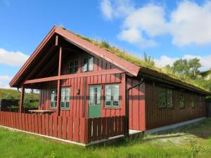 a red house with a grass roof at Holiday Home Brandsbu - SOW097 by Interhome in Åseral