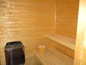 a wooden sauna with a trash can and a bucket at Holiday Home Fjellheimen - SOW138 by Interhome in Åseral