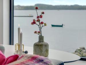 a vase with flowers in it sitting on a table at Holiday Home Florinda - 10m from the sea by Interhome in Haderslev