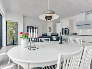 a kitchen and dining room with a white table and chairs at Holiday Home Florinda - 10m from the sea by Interhome in Haderslev +21 photos