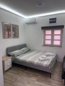 a small bedroom with a bed and a window at Loft Largo Gloria in Messina
